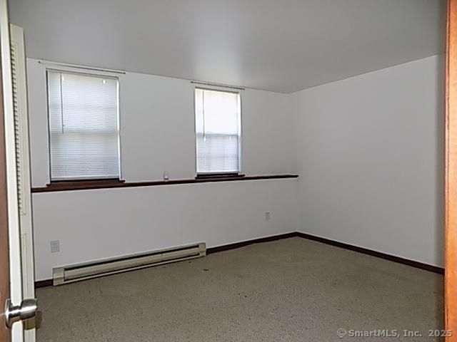 spare room with baseboards and baseboard heating