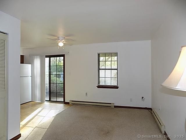 unfurnished room with carpet, a ceiling fan, baseboards, a baseboard radiator, and a baseboard heating unit