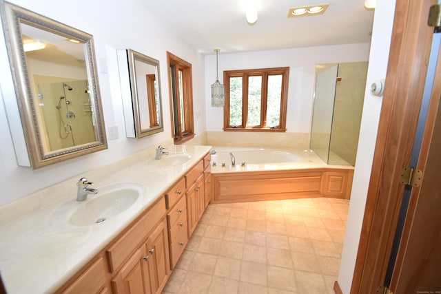 bathroom with a sink, double vanity, a shower with shower door, and a bath