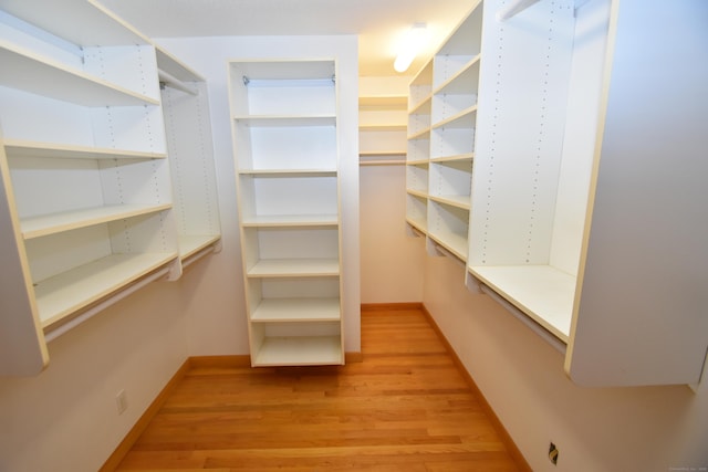 spacious closet featuring light wood-style flooring