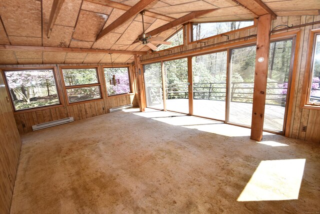 unfurnished sunroom with a ceiling fan, wood walls, a wealth of natural light, and a baseboard radiator