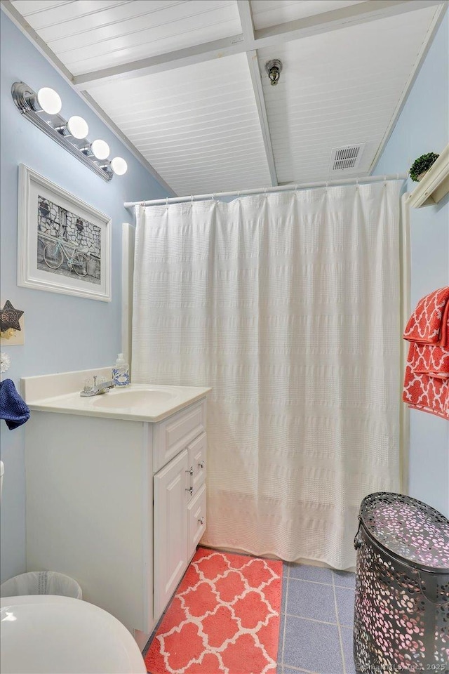 bathroom featuring a shower with curtain, visible vents, tile patterned flooring, and vanity