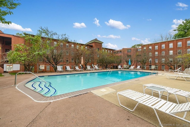 community pool featuring a patio and fence
