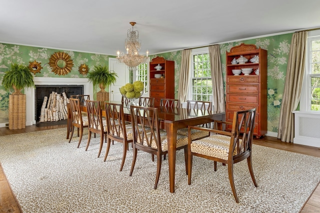 35 Old Redding Rd, Easton, CT 06612 - dining space with wallpapered walls, radiator, a chandelier, light wood-type flooring, and crown molding