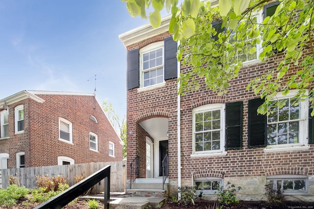 61 Longview Ave, Fairfield, CT 06824 - view of front of house with brick siding and fence