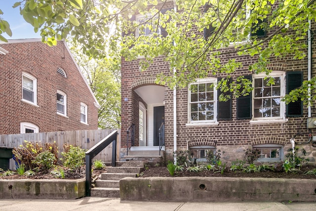 61 Longview Ave, Fairfield, CT 06824 - view of front of home with brick siding and fence