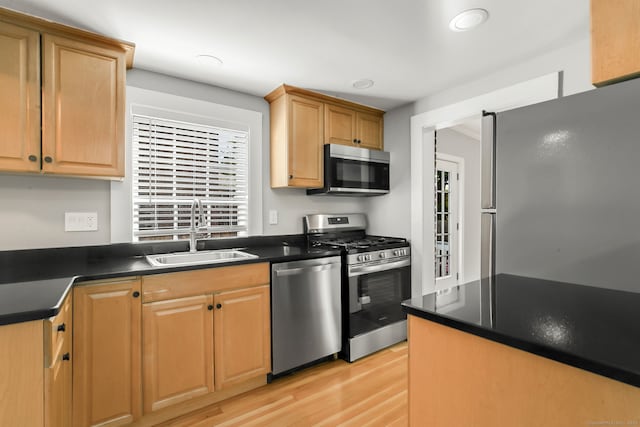 61 Longview Ave, Fairfield, CT 06824 - kitchen featuring dark countertops, a sink, light wood-style floors, stainless steel appliances, and recessed lighting