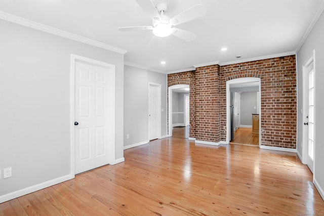 61 Longview Ave, Fairfield, CT 06824 - unfurnished room with a ceiling fan, ornamental molding, light wood-style floors, baseboards, and arched walkways