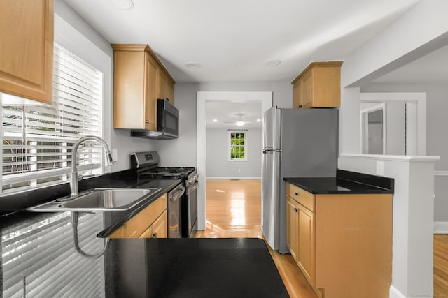 61 Longview Ave, Fairfield, CT 06824 - kitchen featuring stainless steel appliances, a ceiling fan, dark countertops, and light wood-style floors