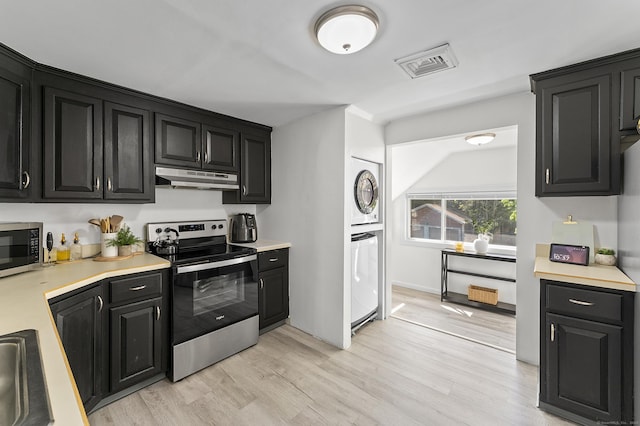 6 Beech St, Bristol, CT 06010 - kitchen featuring visible vents, light countertops, under cabinet range hood, dark cabinetry, and stainless steel appliances
