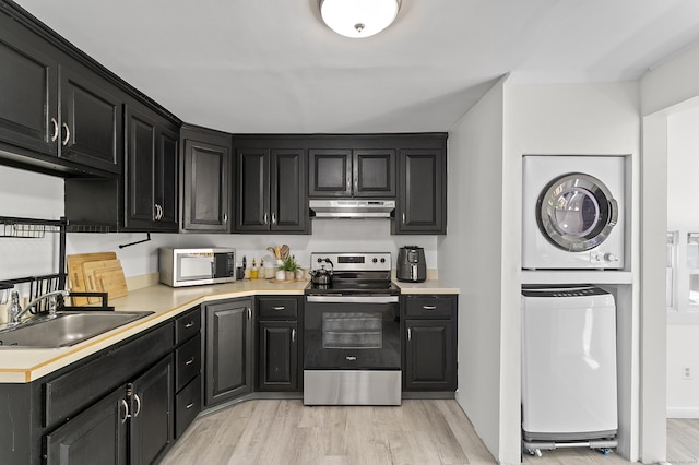 6 Beech St, Bristol, CT 06010 - kitchen with dark cabinets, appliances with stainless steel finishes, light wood-style floors, and stacked washer and dryer