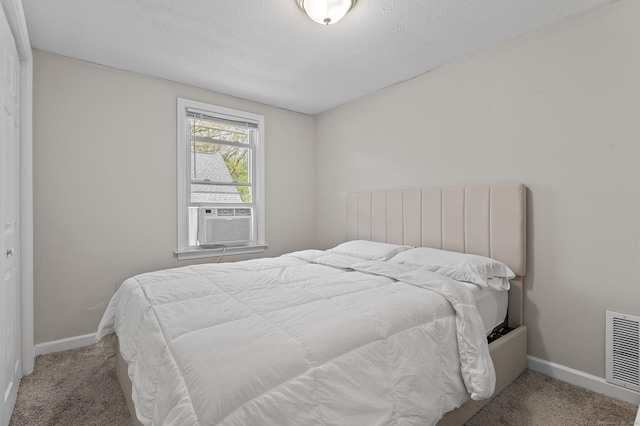 6 Beech St, Bristol, CT 06010 - carpeted bedroom featuring a textured ceiling, baseboards, visible vents, and cooling unit