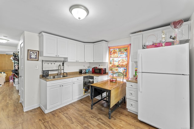 6 Beech St, Bristol, CT 06010 - kitchen featuring freestanding refrigerator, white cabinets, black microwave, and a sink