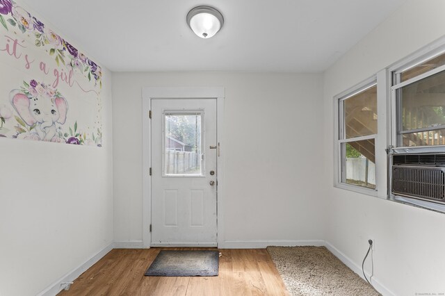 6 Beech St, Bristol, CT 06010 - doorway featuring baseboards, wood finished floors, and cooling unit