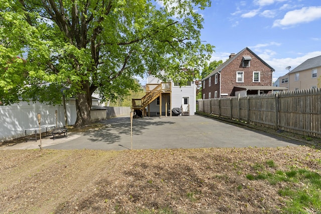 6 Beech St, Bristol, CT 06010 - rear view of property featuring a fenced backyard, stairs, a patio area, and a wooden deck