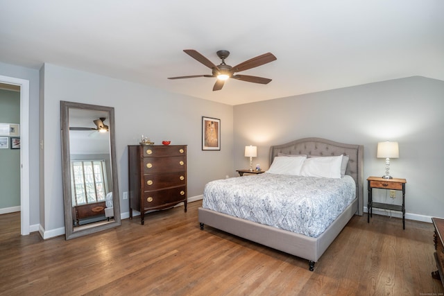 bedroom with baseboards, ceiling fan, and wood finished floors