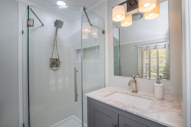full bath featuring crown molding, vanity, visible vents, and a shower stall