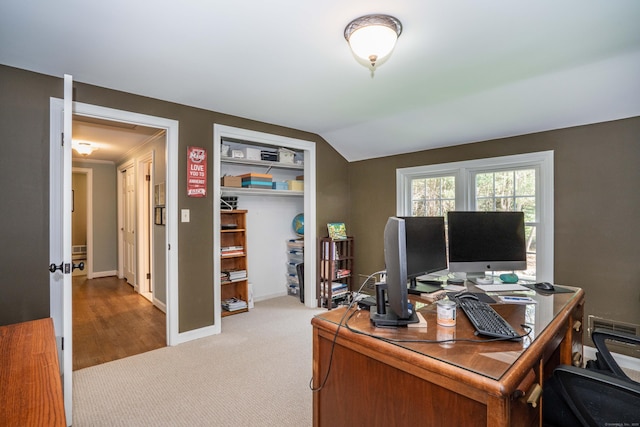home office with baseboards, light carpet, and lofted ceiling