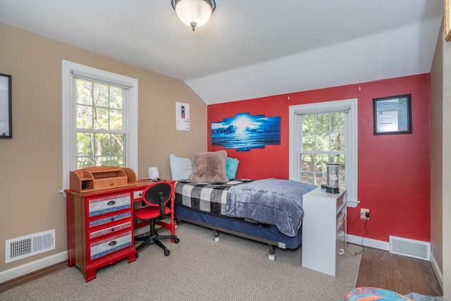 bedroom with baseboards, visible vents, and multiple windows