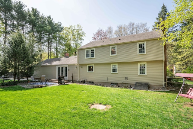rear view of property with a patio and a yard