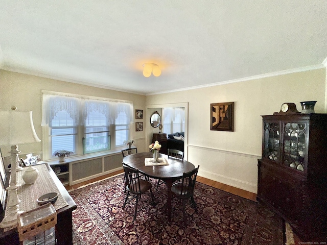 78-80 Lancaster Rd, West Hartford, CT 06119 - dining room with crown molding, baseboards, wood finished floors, and radiator heating unit