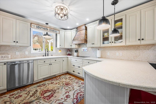 kitchen featuring a sink, premium range hood, dishwasher, black electric cooktop, and a peninsula