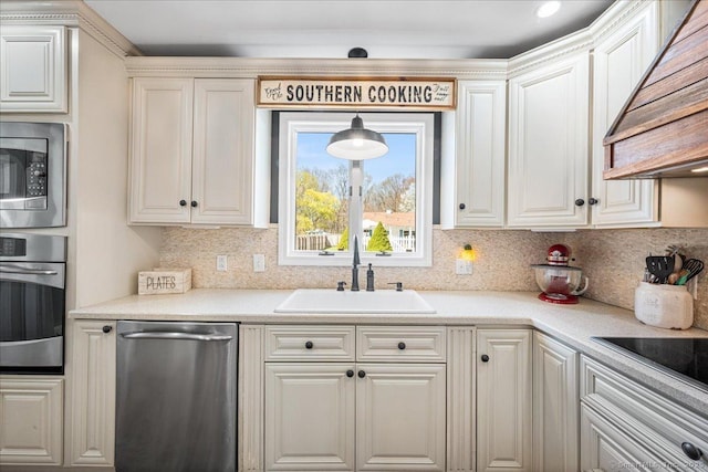 kitchen with custom exhaust hood, appliances with stainless steel finishes, decorative backsplash, and a sink