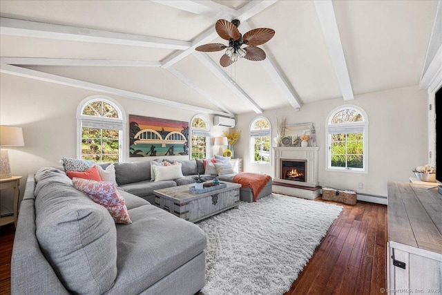 living area featuring ceiling fan, lofted ceiling with beams, a lit fireplace, an AC wall unit, and dark wood-type flooring