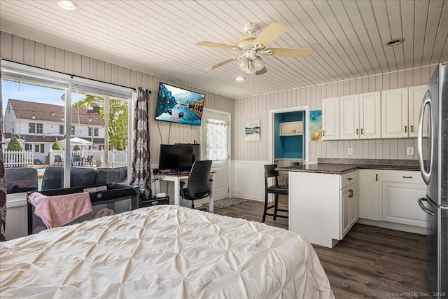 bedroom with dark wood-style floors, recessed lighting, wood ceiling, and freestanding refrigerator