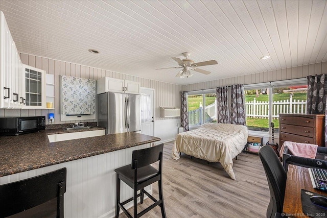bedroom featuring a sink, wooden ceiling, light wood-style floors, ceiling fan, and freestanding refrigerator