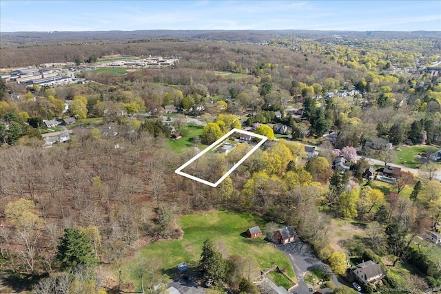 drone / aerial view featuring a forest view