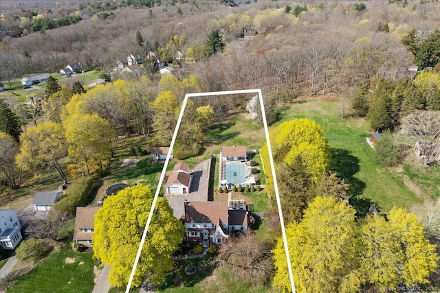 birds eye view of property with a wooded view