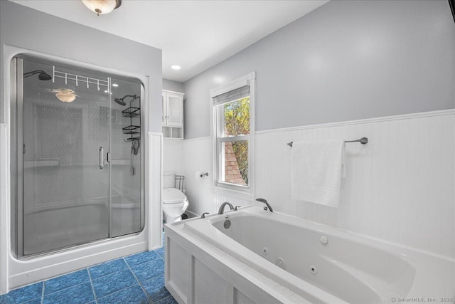 bathroom with a shower stall, a wainscoted wall, toilet, a whirlpool tub, and tile patterned floors