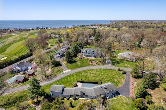 drone / aerial view with a water view and view of golf course