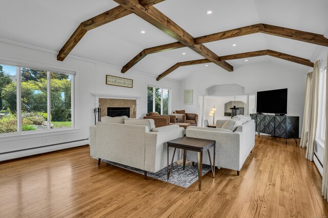 living area featuring a fireplace, a baseboard radiator, lofted ceiling with beams, light wood-style floors, and recessed lighting