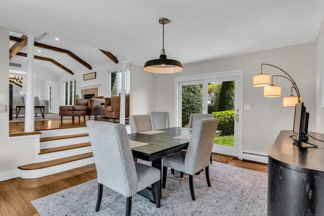 dining area with baseboard heating, a fireplace, wood finished floors, lofted ceiling with beams, and recessed lighting