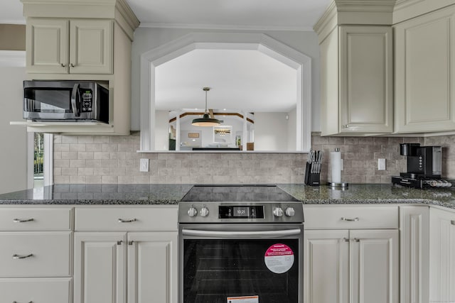 kitchen with dark stone counters, tasteful backsplash, and stainless steel appliances