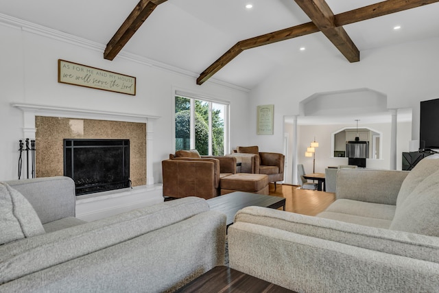 living area featuring a premium fireplace, recessed lighting, vaulted ceiling with beams, and dark wood-type flooring