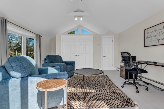 carpeted office featuring baseboards and vaulted ceiling