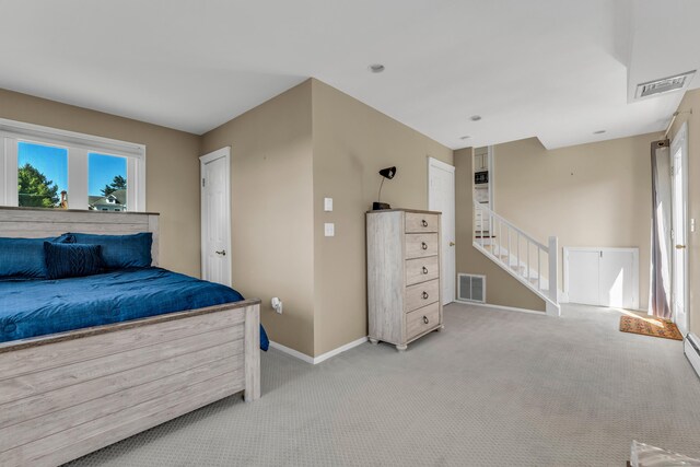 bedroom featuring light colored carpet, baseboards, and visible vents