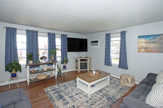 living room with wood finished floors, a baseboard radiator, and a wall mounted AC