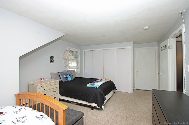 bedroom with light carpet and a closet