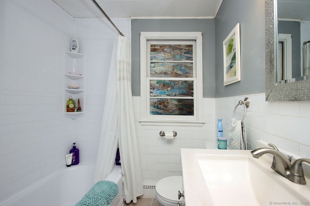 full bath featuring shower / bath combo, tile walls, vanity, toilet, and wainscoting