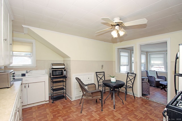 dining room with ceiling fan and ornamental molding