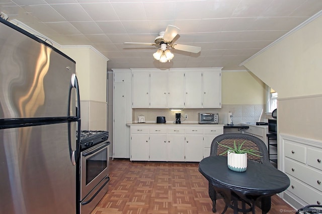 kitchen featuring white cabinetry, stainless steel appliances, and ornamental molding