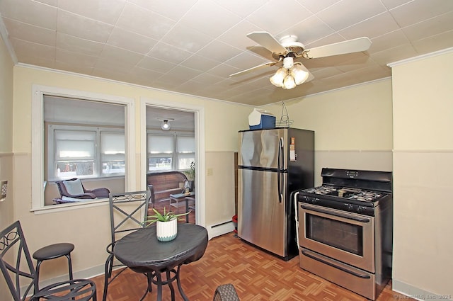 kitchen with ceiling fan, stainless steel appliances, crown molding, and a baseboard heating unit