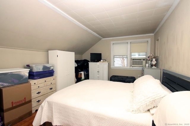 bedroom with crown molding, cooling unit, vaulted ceiling, and wood finished floors