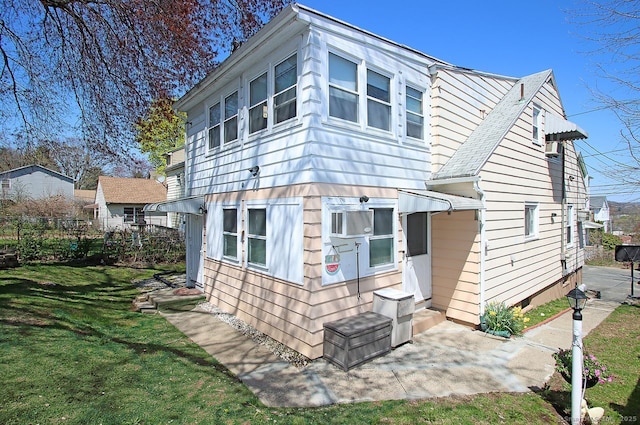 rear view of house featuring a yard
