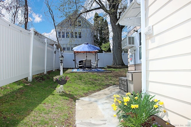 view of yard with a fenced backyard, outdoor dining area, and a patio area