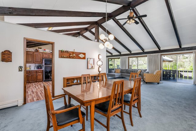 dining area featuring ceiling fan with notable chandelier, vaulted ceiling with beams, light carpet, and a baseboard heating unit